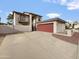 Two-story home featuring a balcony, stucco exterior, a detached garage, and a long driveway at 1810 W Kiowa Cir, Mesa, AZ 85202