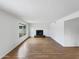 Bright, empty living room featuring a modern fireplace, wood floors and large windows at 1810 W Kiowa Cir, Mesa, AZ 85202