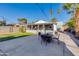 Spacious backyard perfect for outdoor entertaining with a table, chairs, and landscaped lawn at 1822 N Laurel Ave, Phoenix, AZ 85007