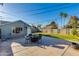 Charming backyard features a patio with an outdoor dining area and spacious grassy area at 1822 N Laurel Ave, Phoenix, AZ 85007