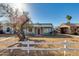 Charming home featuring a red door, light blue facade and mature trees at 1822 N Laurel Ave, Phoenix, AZ 85007