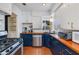 Charming kitchen with stainless steel appliances, dark blue cabinets and butcher block countertops at 1822 N Laurel Ave, Phoenix, AZ 85007