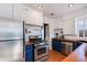 Functional kitchen featuring stainless steel appliances, terracotta floor, and white cabinets at 1822 N Laurel Ave, Phoenix, AZ 85007