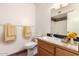 Bathroom featuring a toilet, towels, vanity with sink, and a mirror with lights at 1859 E Gemini Dr, Tempe, AZ 85283