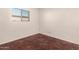 Bright bedroom showcases stained concrete floors, a small window, and white walls with outlets at 1859 E Gemini Dr, Tempe, AZ 85283