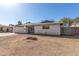 Single-story home exterior featuring a low-maintenance front yard and attached garage at 1859 E Gemini Dr, Tempe, AZ 85283