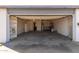 Spacious garage with shelving, a water heater, and an open door revealing the exterior at 1859 E Gemini Dr, Tempe, AZ 85283