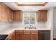 Bright kitchen featuring wood cabinetry, stainless steel appliances, and a functional layout at 1859 E Gemini Dr, Tempe, AZ 85283