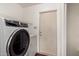 Laundry room equipped with an Electrolux washer and dryer, along with a white door at 1859 E Gemini Dr, Tempe, AZ 85283