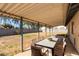 Covered patio with a dining table and chairs overlooks a spacious yard with block fencing at 1859 E Gemini Dr, Tempe, AZ 85283