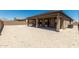 An empty backyard with a covered patio, awaiting personalization and landscaping to become an outdoor oasis at 20261 W Monterey Way, Buckeye, AZ 85396