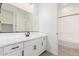 This bathroom features a large vanity with matte black fixtures, a mirror, and a shower at 20261 W Monterey Way, Buckeye, AZ 85396