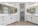 Bright bathroom with dual sinks, white cabinets, and a walk-in closet at 20261 W Monterey Way, Buckeye, AZ 85396