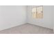 Empty bedroom with carpet, window, and base molding at 20261 W Monterey Way, Buckeye, AZ 85396