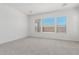 Inviting bedroom with neutral walls, plush carpeting, and large windows offering natural light at 20261 W Monterey Way, Buckeye, AZ 85396