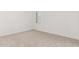 This bedroom has neutral carpet, white walls, and a window to let in natural light at 20261 W Monterey Way, Buckeye, AZ 85396