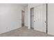 Neutral bedroom with carpet floors, closet and doorway at 20261 W Monterey Way, Buckeye, AZ 85396