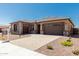 Beautiful single-story home with a three-car garage, desert landscaping, and a paved driveway at 20261 W Monterey Way, Buckeye, AZ 85396