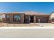 Beautiful single-story home featuring stone accents, a tile roof, and a well-manicured front yard at 20261 W Monterey Way, Buckeye, AZ 85396