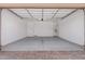 Spacious three-car garage with painted walls and concrete flooring, perfect for parking and storage at 20261 W Monterey Way, Buckeye, AZ 85396