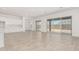 Open-concept living room with tile floors and sliding glass doors to the backyard at 20261 W Monterey Way, Buckeye, AZ 85396