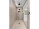 Walk-in shower featuring neutral-toned tile and modern fixtures at 20261 W Monterey Way, Buckeye, AZ 85396