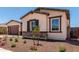 Charming single-story home featuring stucco siding, stone accents, and a well-manicured front yard at 20273 W Monterey Way, Buckeye, AZ 85396