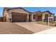 Charming home featuring a three-car garage, inviting curb appeal, and a paved driveway at 20273 W Monterey Way, Buckeye, AZ 85396