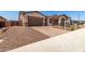 Inviting home featuring a three-car garage, nicely landscaped front yard, and paved driveway at 20273 W Monterey Way, Buckeye, AZ 85396
