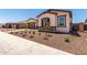 Attractive front elevation with manicured landscaping and a well-maintained lawn enhance curb appeal at 20273 W Monterey Way, Buckeye, AZ 85396