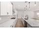 Well-lit kitchen with quartz countertops, a large island, stainless steel appliances, and ample storage at 20273 W Monterey Way, Buckeye, AZ 85396