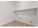 Functional laundry room with ample shelving for storage, making chores a breeze at 20273 W Monterey Way, Buckeye, AZ 85396