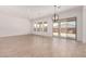 Expansive living room with tile flooring, large windows, and a sliding glass door to the backyard at 20273 W Monterey Way, Buckeye, AZ 85396