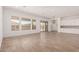 Spacious living area with tile flooring, large windows, sliding glass door, and white kitchen cabinets at 20273 W Monterey Way, Buckeye, AZ 85396