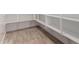 Walk-in pantry featuring abundant shelving for organized storage and wood-style flooring at 20273 W Monterey Way, Buckeye, AZ 85396
