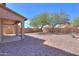 Backyard with a covered patio and views of mature trees at 21354 N Denver Ct, Maricopa, AZ 85138