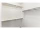 This walk-in closet has shelving and rods for organized storage at 21354 N Denver Ct, Maricopa, AZ 85138