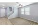 Bright living room featuring neutral paint, plush carpet, natural light, and tile flooring at 21354 N Denver Ct, Maricopa, AZ 85138