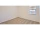 Cozy bedroom featuring neutral carpet, white walls, and a window at 21949 E Twin Acres Dr, Queen Creek, AZ 85142