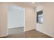 Bonus room featuring wood-look tile floors, white walls, and a window at 21949 E Twin Acres Dr, Queen Creek, AZ 85142