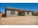 Exterior rear view of a single-story house, with a covered patio and desert landscaping potential at 21949 E Twin Acres Dr, Queen Creek, AZ 85142