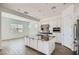 Open-concept kitchen with stainless steel appliances, a spacious island, and white cabinets at 21949 E Twin Acres Dr, Queen Creek, AZ 85142