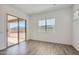 Bright room with wood-look flooring, a sliding glass door, and a large window at 21949 E Twin Acres Dr, Queen Creek, AZ 85142