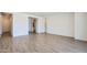 Bright living room featuring wood-look tile flooring, white walls, and an open layout at 21949 E Twin Acres Dr, Queen Creek, AZ 85142