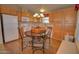 Well-lit kitchen featuring wooden cabinets, modern appliances, and a round dining table with chairs at 2263 N Trekell Rd # 81, Casa Grande, AZ 85122