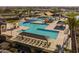 Aerial view of a luxurious community pool with ample lounge chairs and shade structures at 23102 E Raven Dr, Queen Creek, AZ 85142