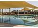 Community pool with shade structures, a splash pad, and various amenities for residents at 23102 E Raven Dr, Queen Creek, AZ 85142