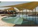 Community pool featuring shade structures, lounge chairs and water feature. Perfect for summer relaxation! at 23102 E Raven Dr, Queen Creek, AZ 85142