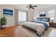 Bedroom with wood floors, neutral walls, a ceiling fan, and bright windows at 2323 W Carson Rd, Phoenix, AZ 85041