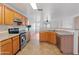 Kitchen featuring oak cabinets, granite countertops, stainless appliances, and tile floors at 2323 W Carson Rd, Phoenix, AZ 85041